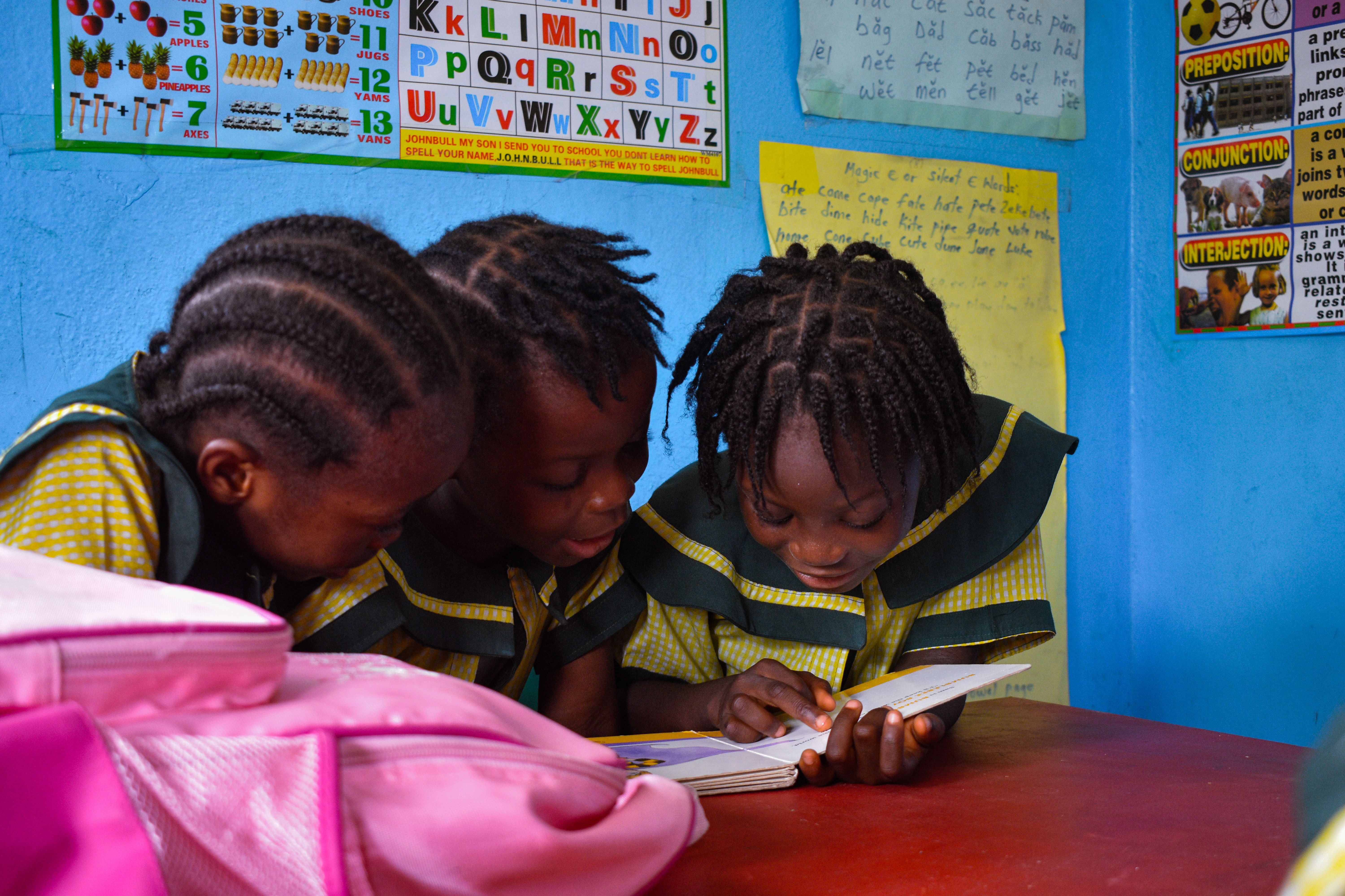 Schoolgirls reading at a school in Monrovia, Liberia Photo by B. Aristotlè Guweh Jr, freely accessible with credit at Pexels  