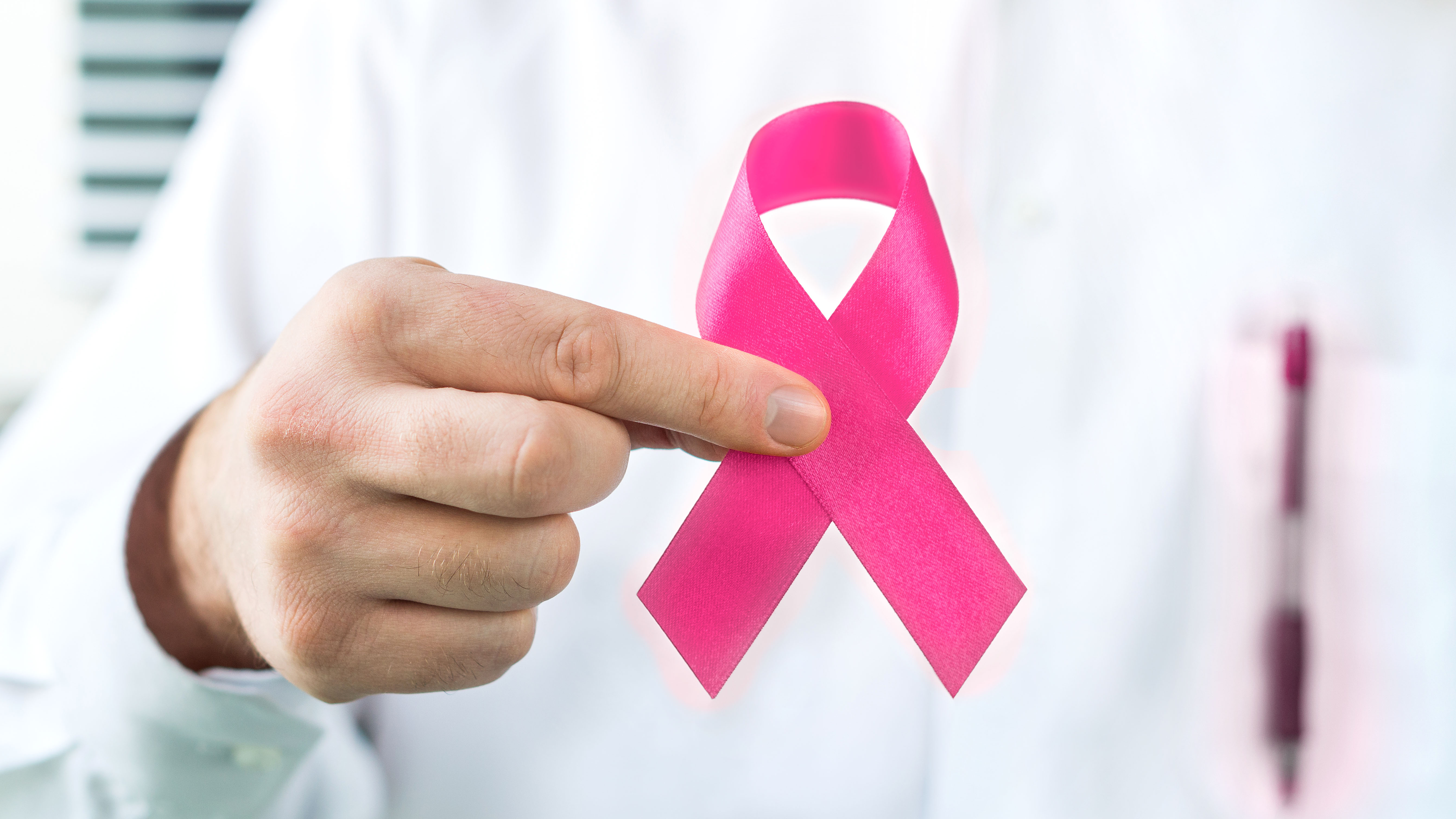 Getty images / hand holding pink cancer awareness ribbon