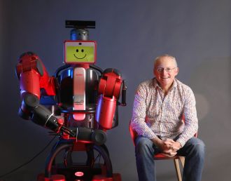 Prof Toby Walsh with a Baxter robot 