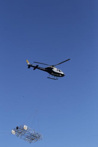 The helicopter-borne radar antenna system flying over Lago Argentino