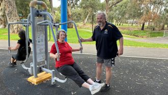 Woman on outdoor exercise equipment. 