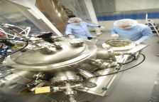 Researchers from CSIRO labs coating the optics