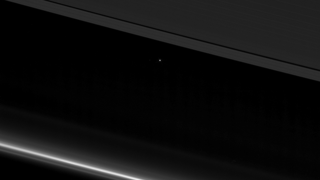 NASA - Cassini's last photo of earth through the rings of Saturn