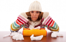 Flu-season_woman-with-thermometer-and-tissues.PNG