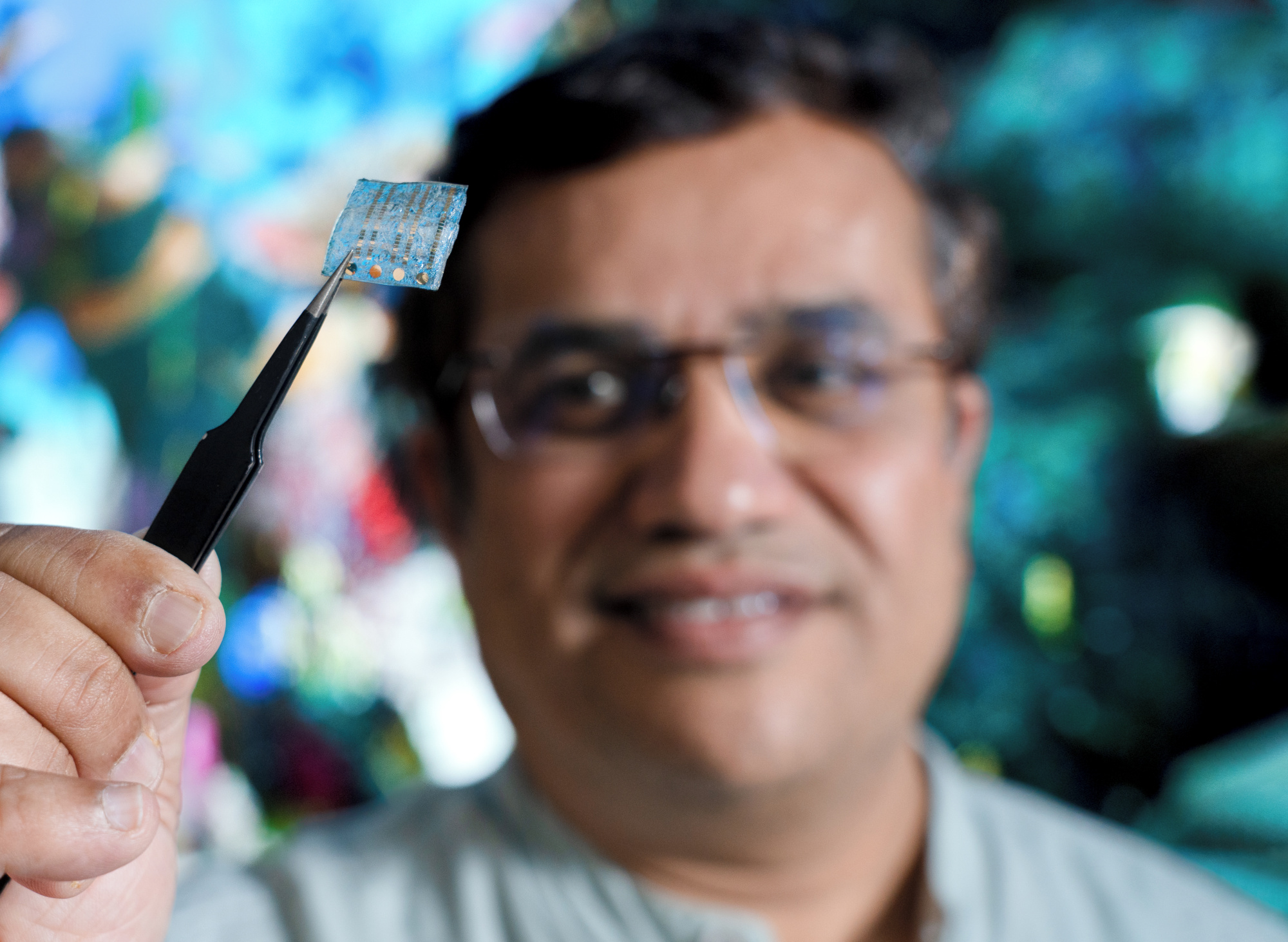 Professor Prashant Sonar with a prototype electronic device using a material made from seafood waste. credit: QUT