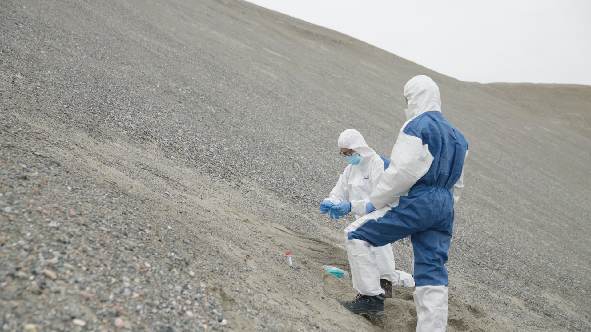 Prof. Eske Willerslev and a colleague sample sediments for environmental DNA in Greenland. Credit: Handful of Films