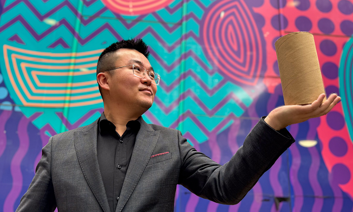 Image of study lead author Dr Jiaming Ma holding the cardboard-confined rammed earth material. Credit: RMIT University