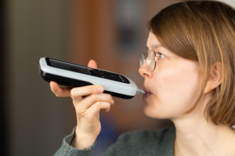 Participant using the breath acetone analyser