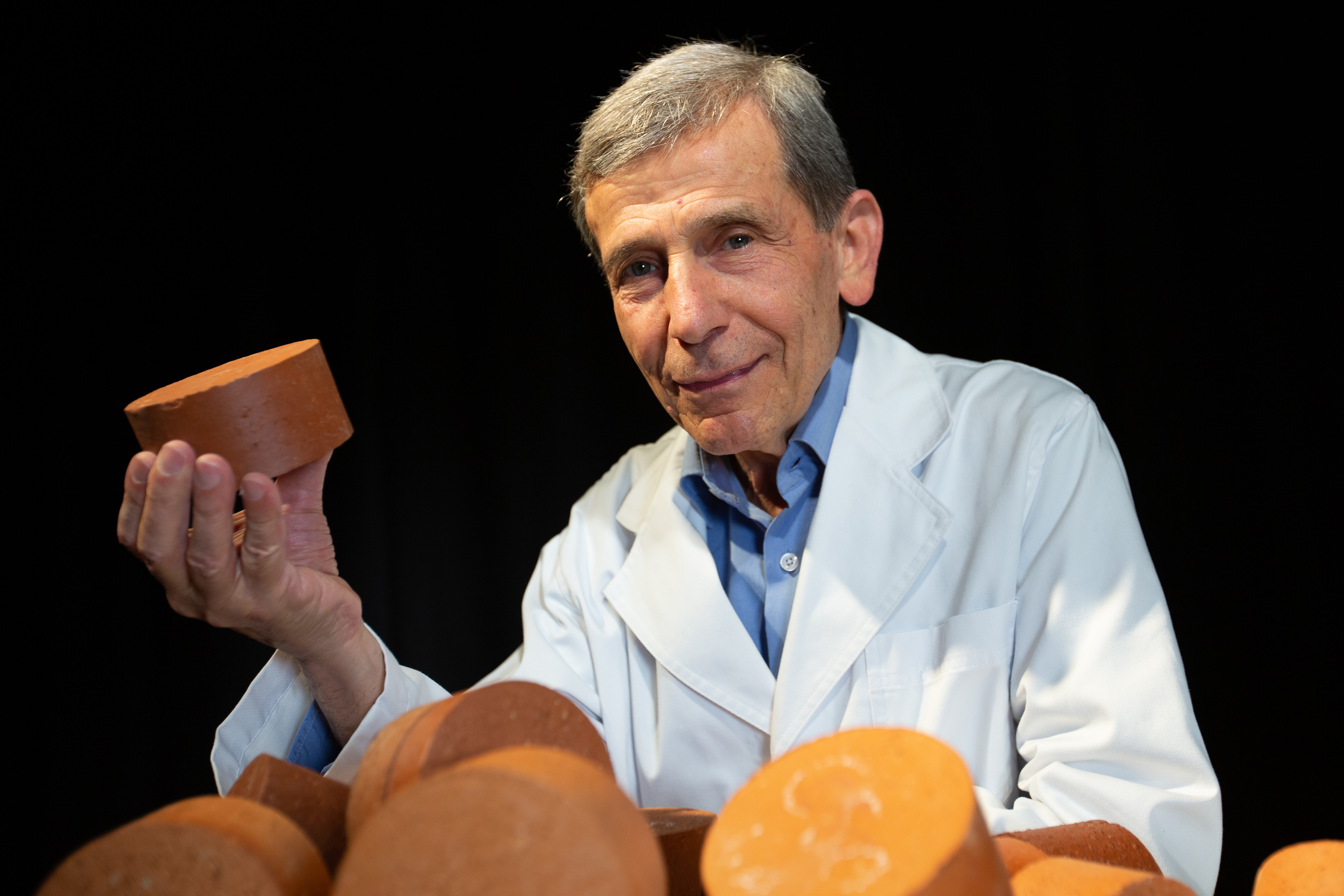 Associate Professor Abbas Mohajerani with a biosolids brick