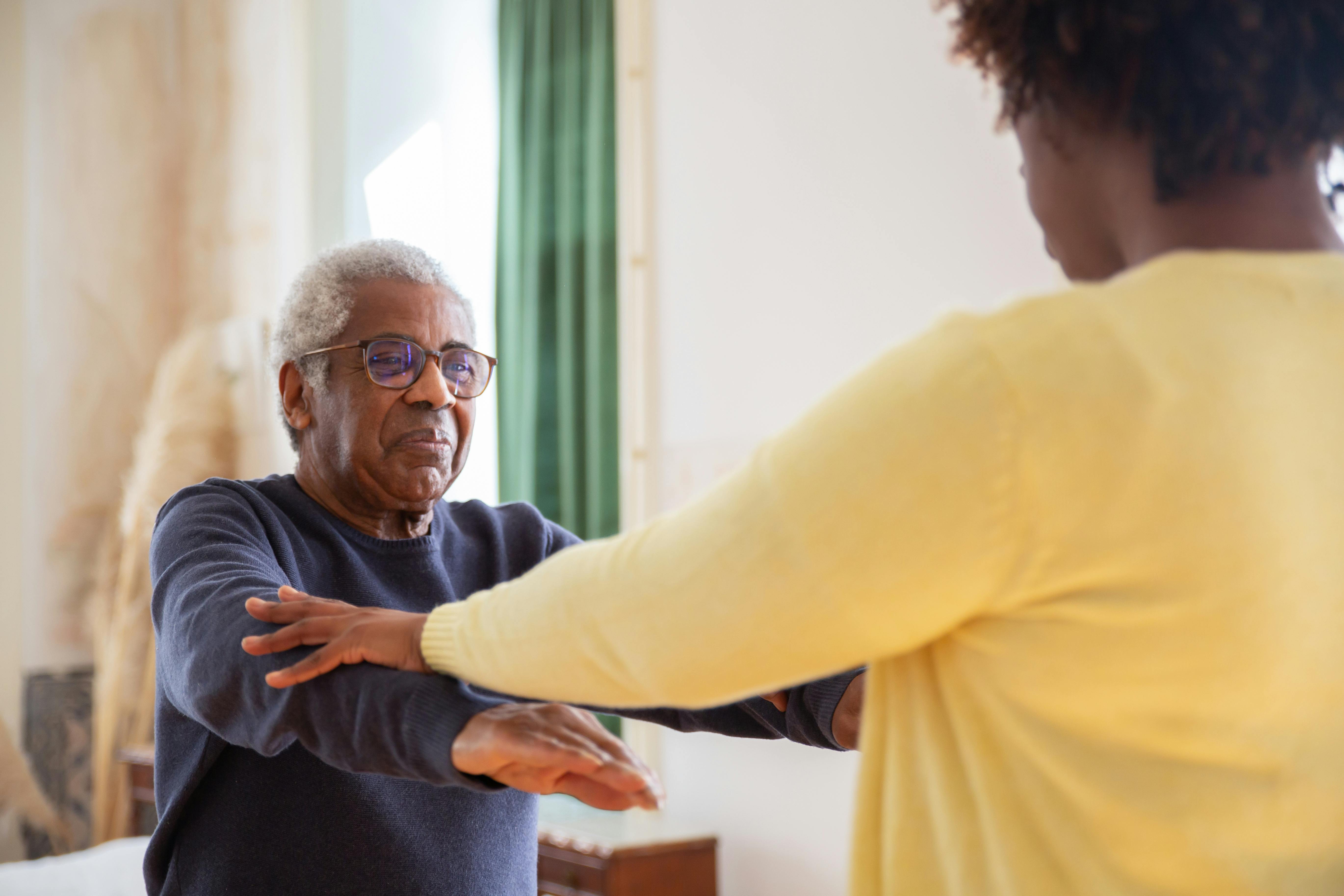 An older man does exercises with assistance from a woman. Credit: Kampus Production / Pexels CC0