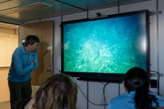 Dr Tim O'Hara watching underwater camera footage