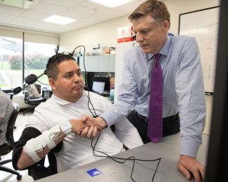 Keith Thomas (left) who lives with paralysis, can now feel touch