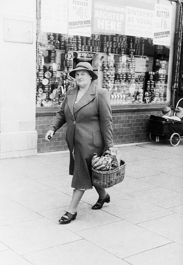 A housewife carrying a shopping basket full of bananas following a walk to a grocery store.  Credit:  HU92467
