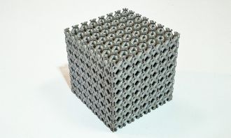 A sample of the new titanium lattice structure 3D printed in cube form. 