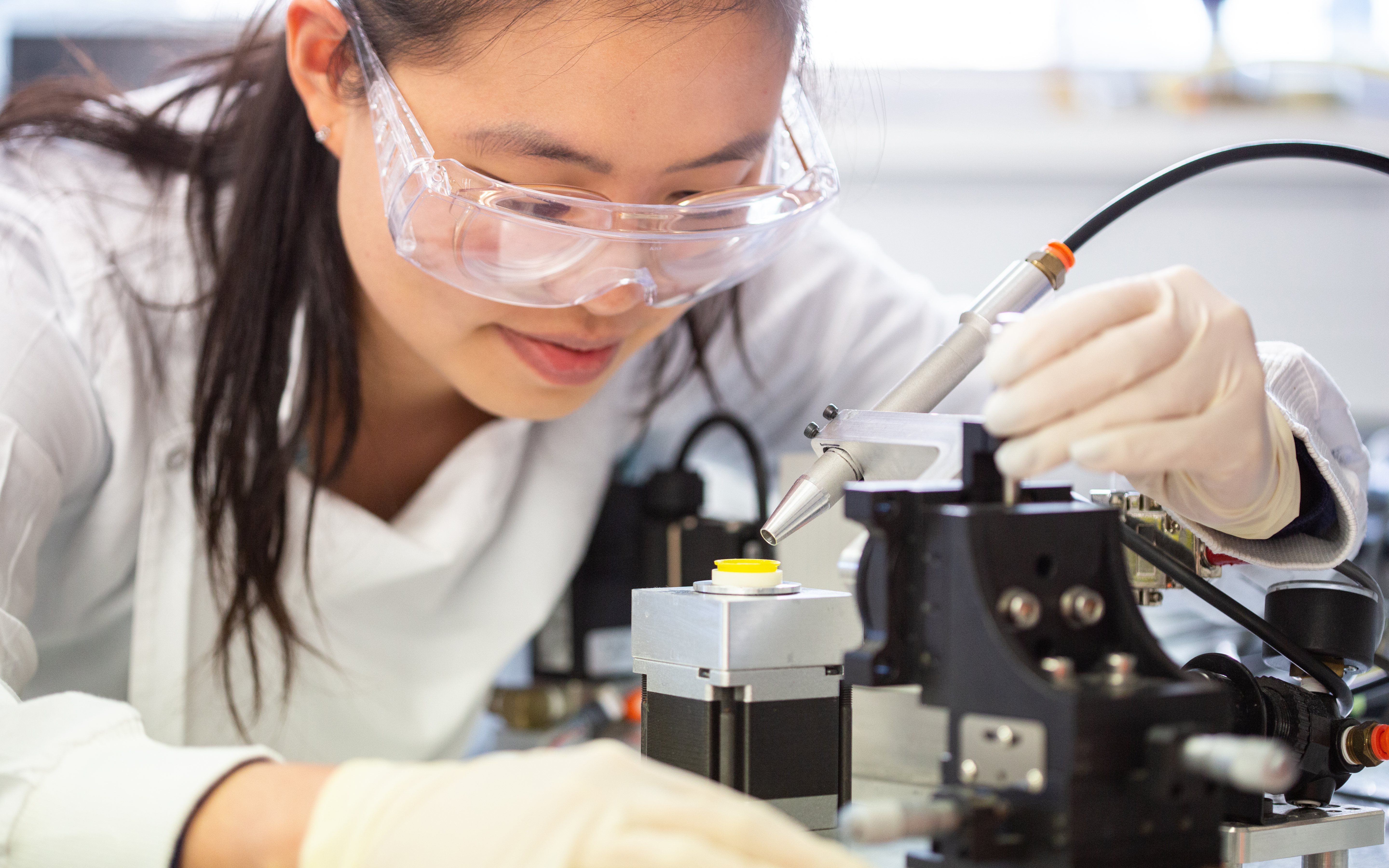 Dr Jovin Choo applying vaccine to the high-density microarray patch (HD-MAP). Credit: UQ