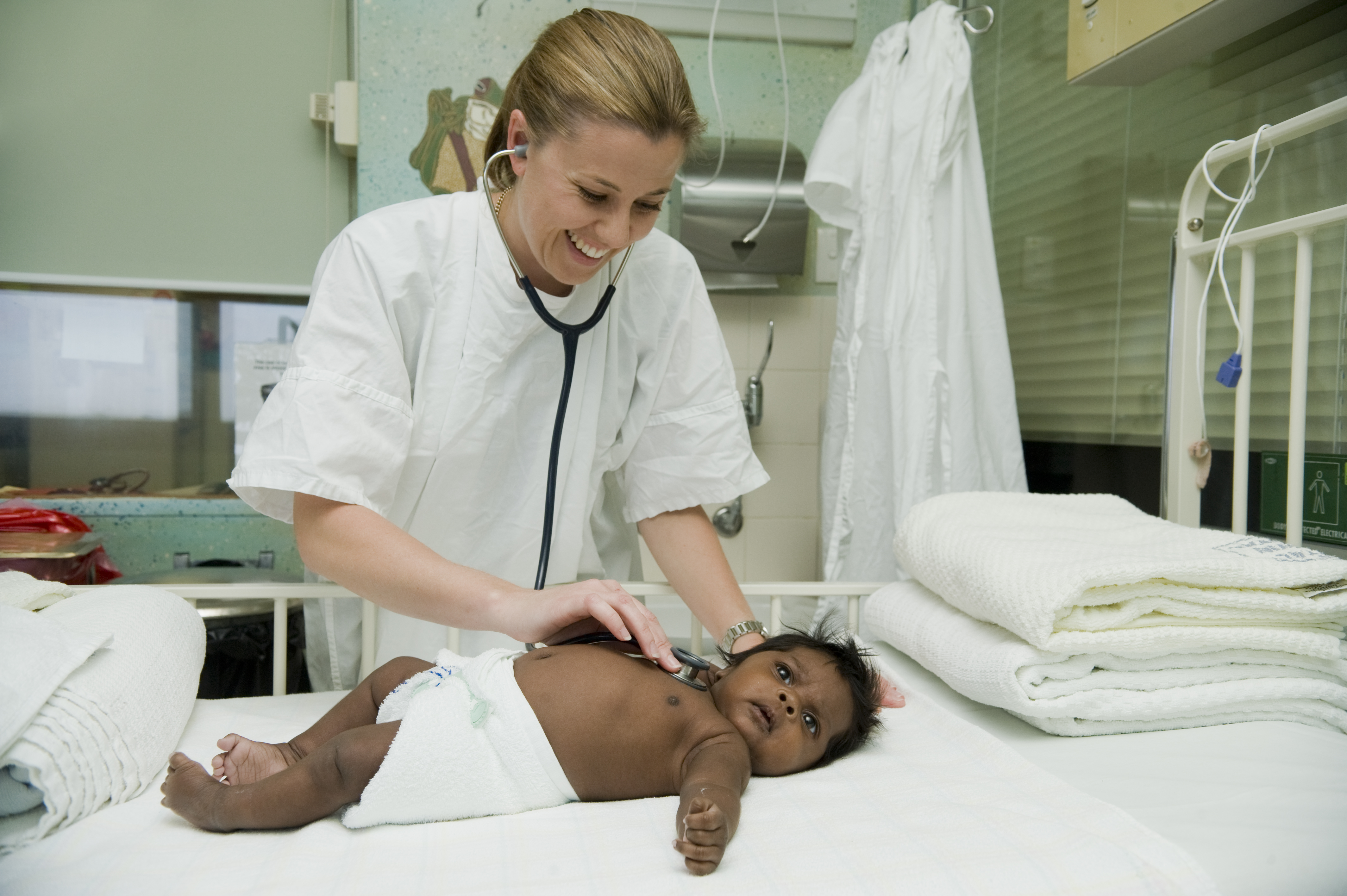 CONSENTED WITH CDU PERMISSION_Nurse and PhD student Gabrielle McCallum examining a baby at Royal Darwin Hospital with acute bronchiolitis 
