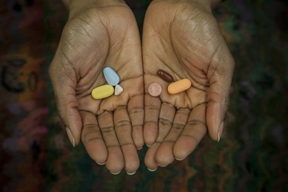 A person holds medications. Limited access to diagnostics and medicines will worsen treatment quality, inducing resistance to antiretrovirals and medicines for infections. Credit: Institute of Tropical Medicine (ITM), Antwerp, CC-BY 4.0 (https://creativecommons.org/licenses/by/4.0/) 