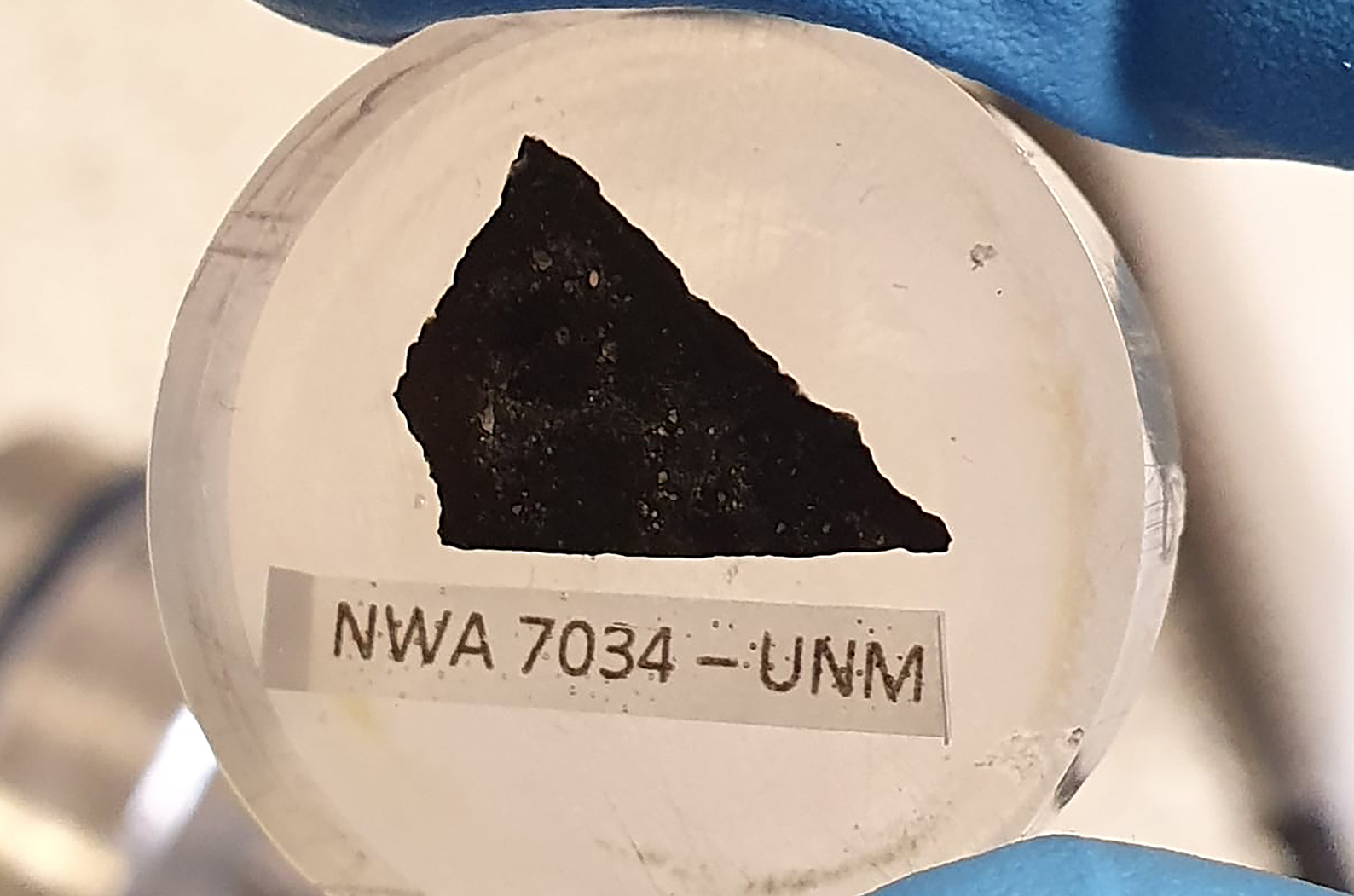 A sample of Martian meteorite NWA 7034 (AKA 'Black Beauty') in epoxy resin. Picture: Aaron Cavosie