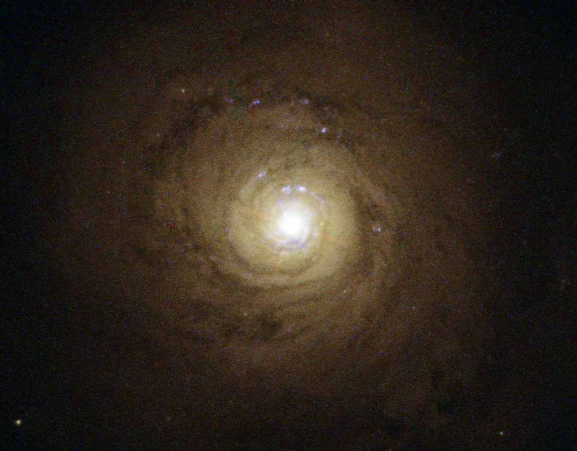 Galaxy NGC 5548. At its heart, though not visible here, is a supermassive black hole behaving in a strange and unexpected manner. Researchers detected a clumpy gas stream flowing quickly outwards and blocking 90 percent of the X-rays emitted by the black hole. This activity could provide insights into how supermassive black holes interact with their host galaxies. Credit: ESA/Hubble, A. Riess et al., J. Greene