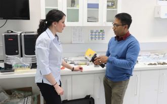 Dr Debashish Mazumder holds the Olympus FXS scanner, provided by Olympus