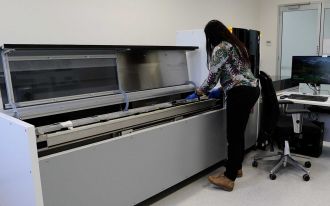 Patricia Gadd handles an organic sample using the full-sized itrax scanner.