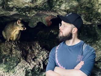 A friendly possum (left) and Tom Jameson (right). 
