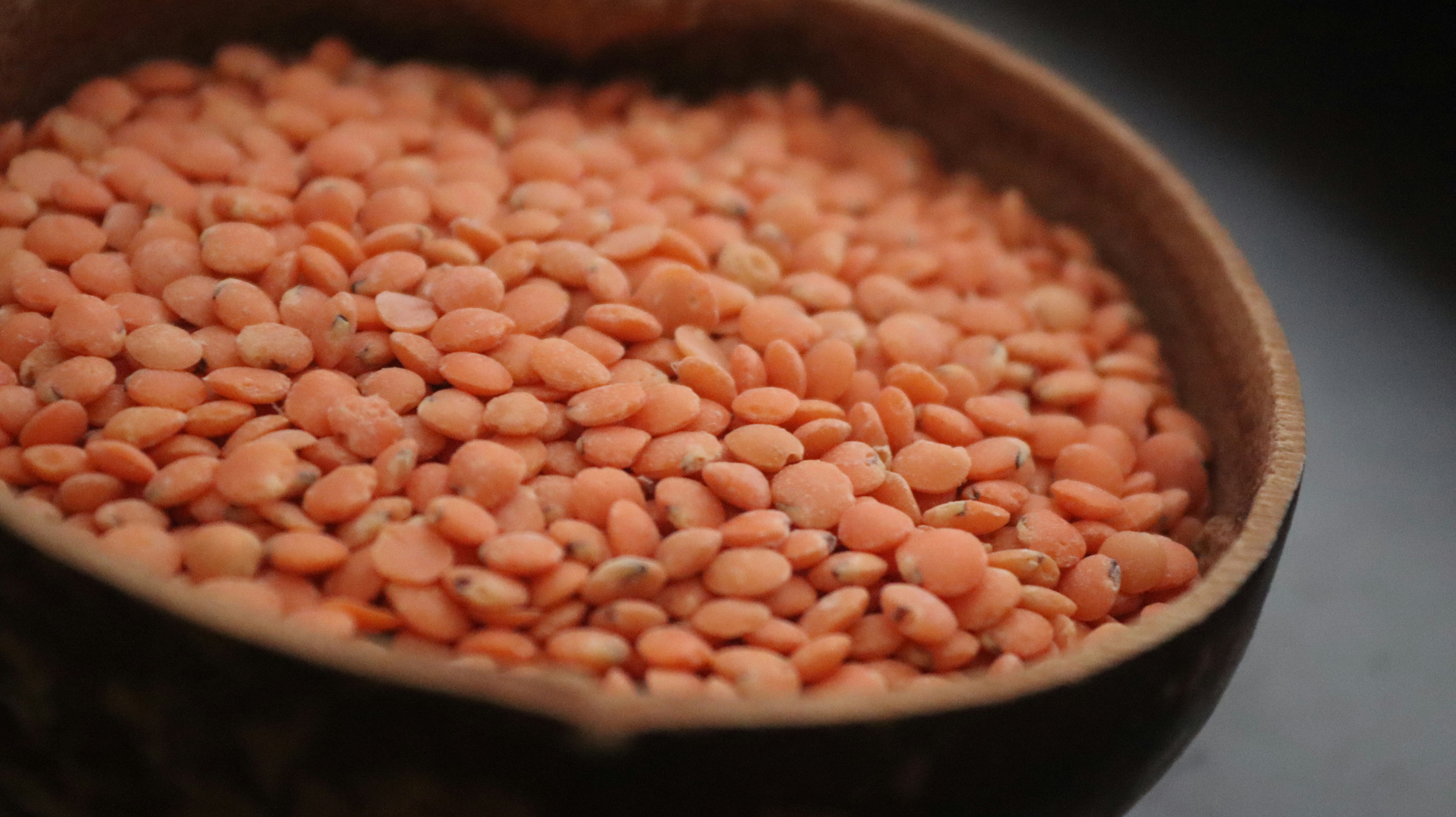 CC-0. https://unsplash.com/photos/a-wooden-bowl-filled-with-red-beans-on-top-of-a-table-ThLPgIo_lH0
