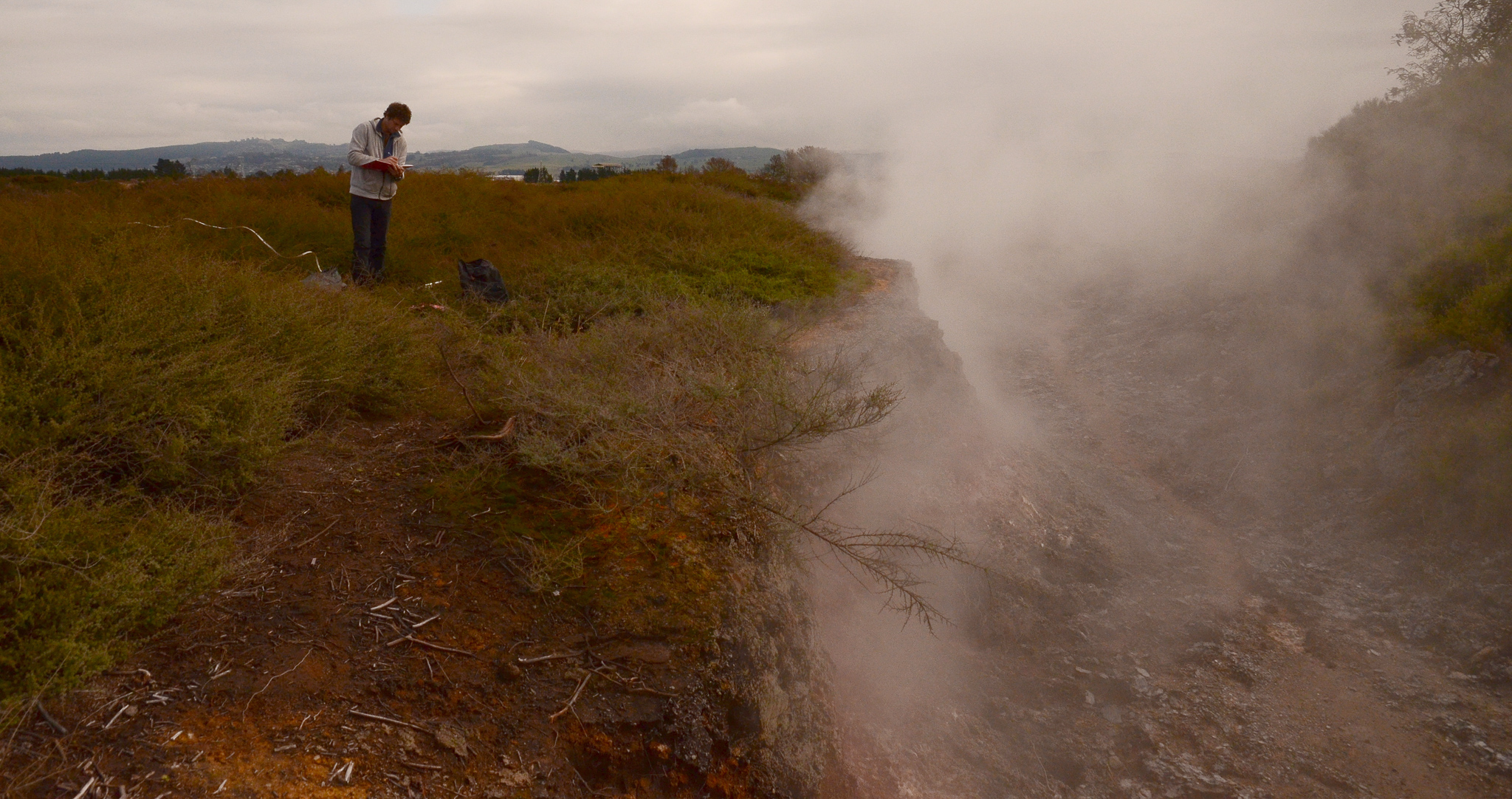  Manaaki Whenua Landcare Research - Gabriel Moinet sampling at the edge of the steam-heated depression, a geo-thermal feature near Taupō