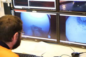 CSIRO staff monitor footage of the wreck from the drop camera.