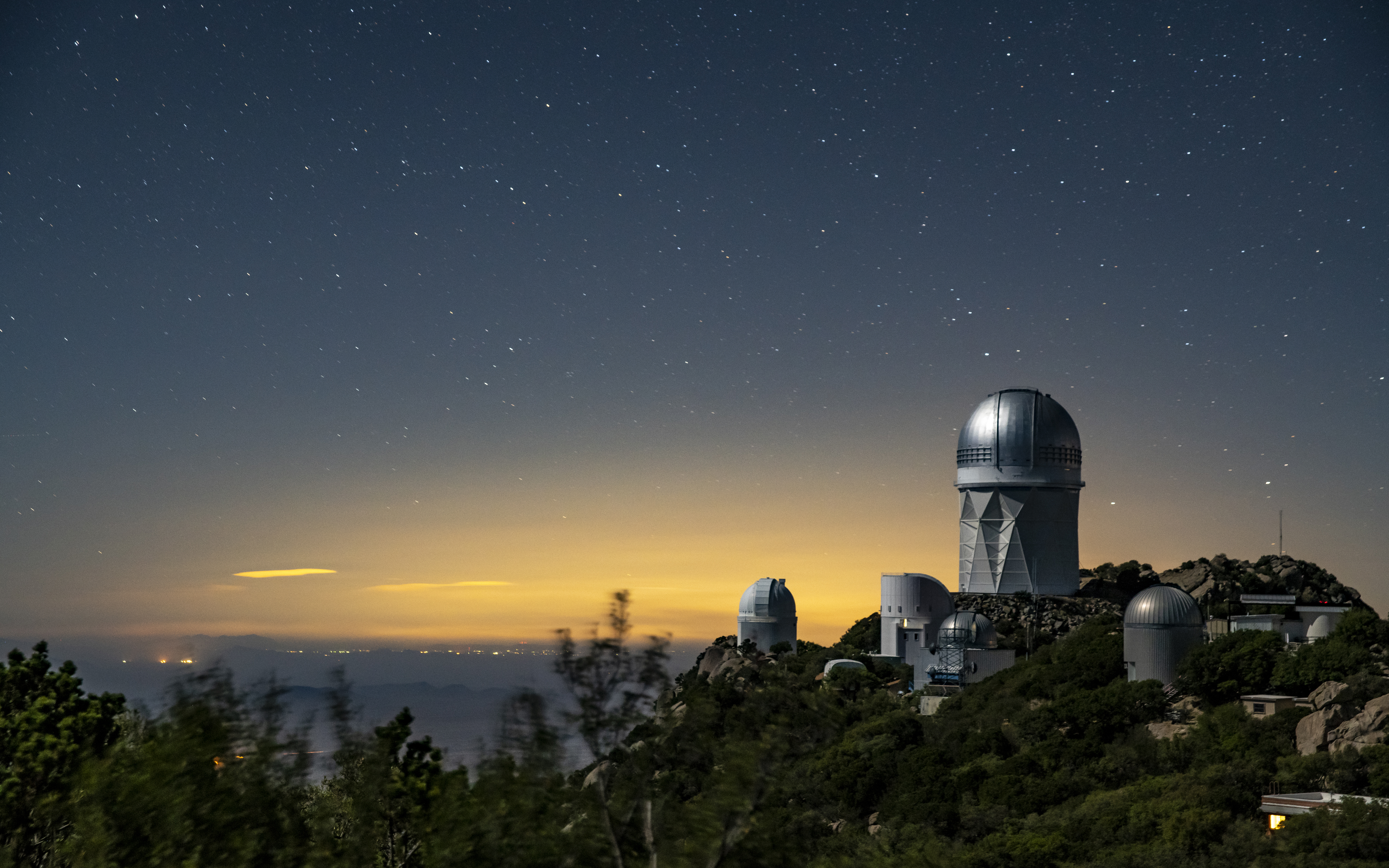 A view of the Mayall Telescope (tallest telescope at right) at Kitt Peak National Observatory near Tucson, Arizona.