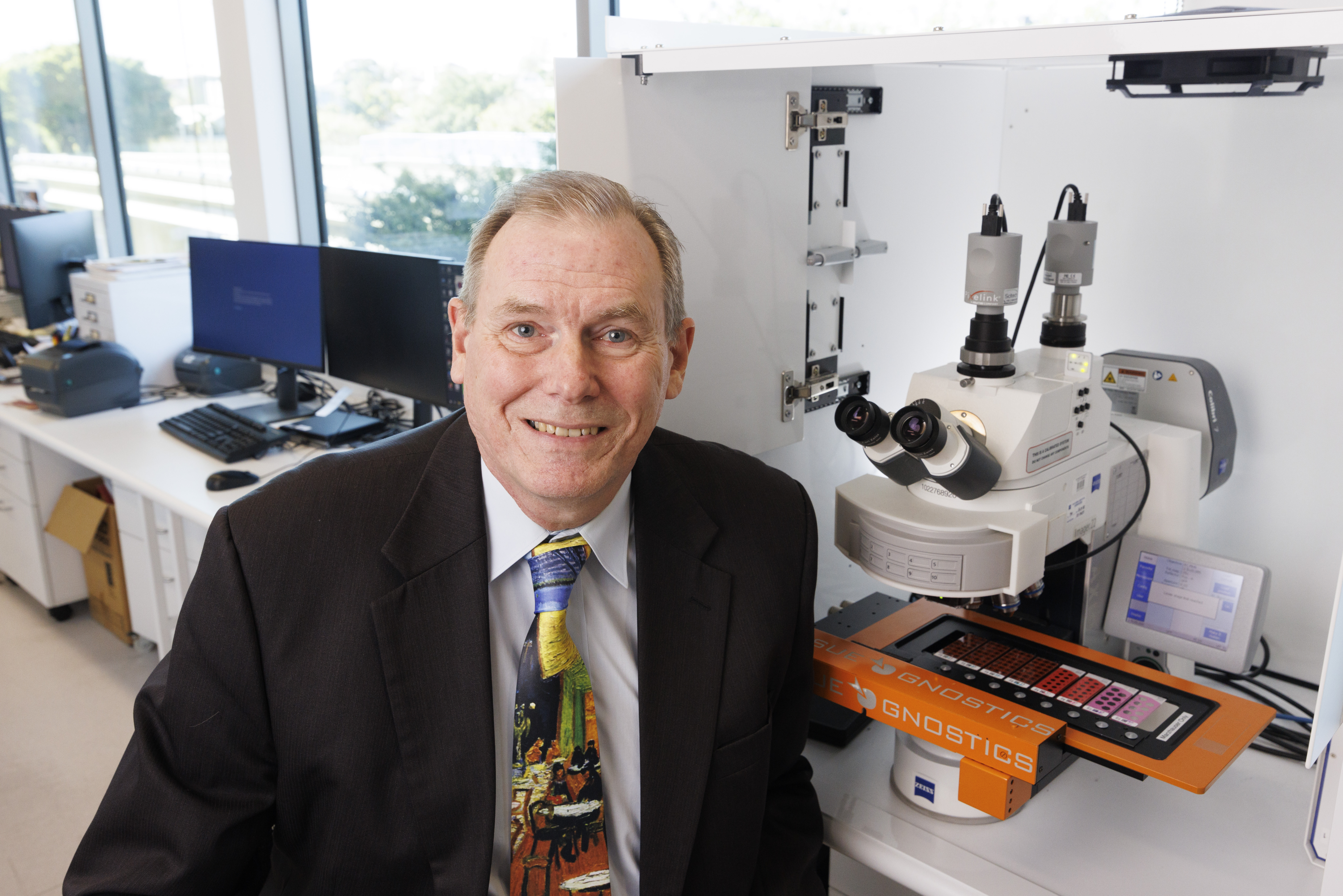 Professor Brian Lovell with an automated microscope scanner