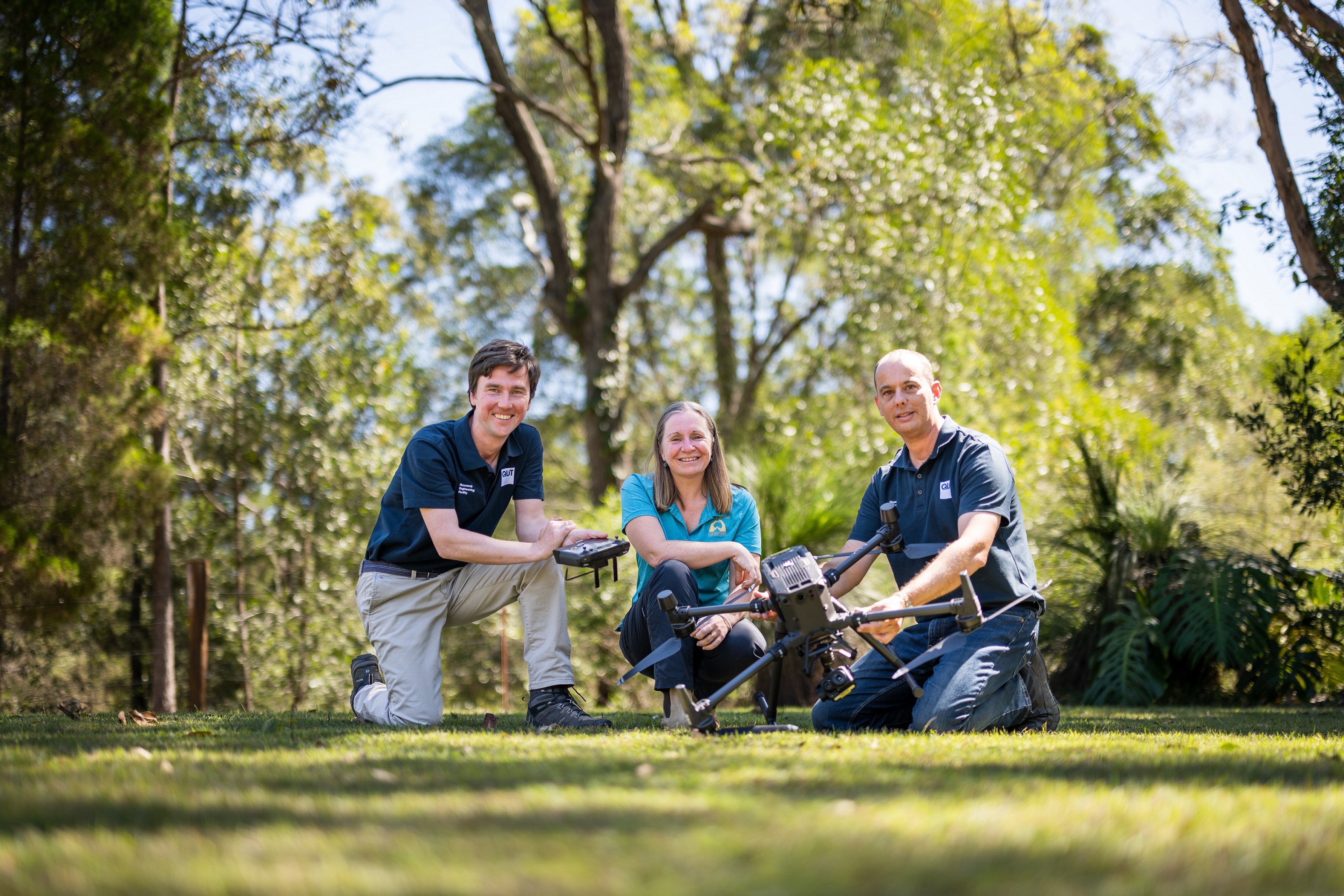 Noosa Landcare member Rachel Lyons with QUT drone trainers Dmitry Bratanov (left) and Gavin Broadbent (right) at QUT's Samford Ecological Research Facility. Photo: Tony Phillips