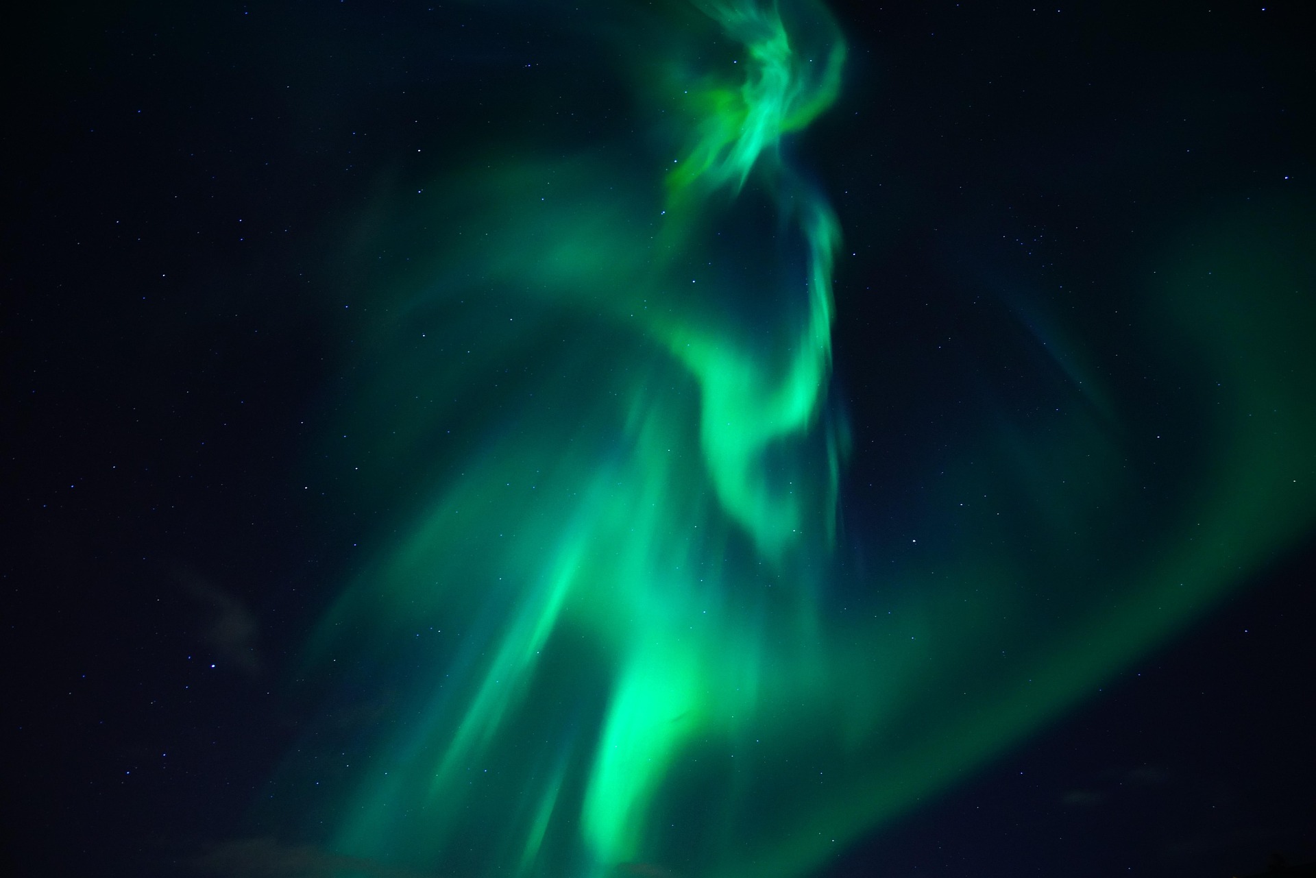 The Northern Lights, or aurora borealis, are caused by the interaction of charged particles from the Sun with Earth's magnetic field and atmosphere. Photo courtesy Hans (Pixabay).