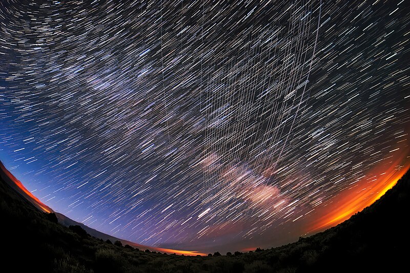 Starlink Satellites pass overhead near Carson National Forest, New Mexico, photographed soon after launch. By M. Lewinsky via wikimedia commons/Creative Commons Attribution 2.0  