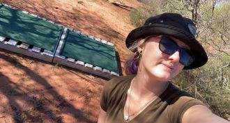 Researcher Tenaya Duncan in the field with a wooden pallet refuge.