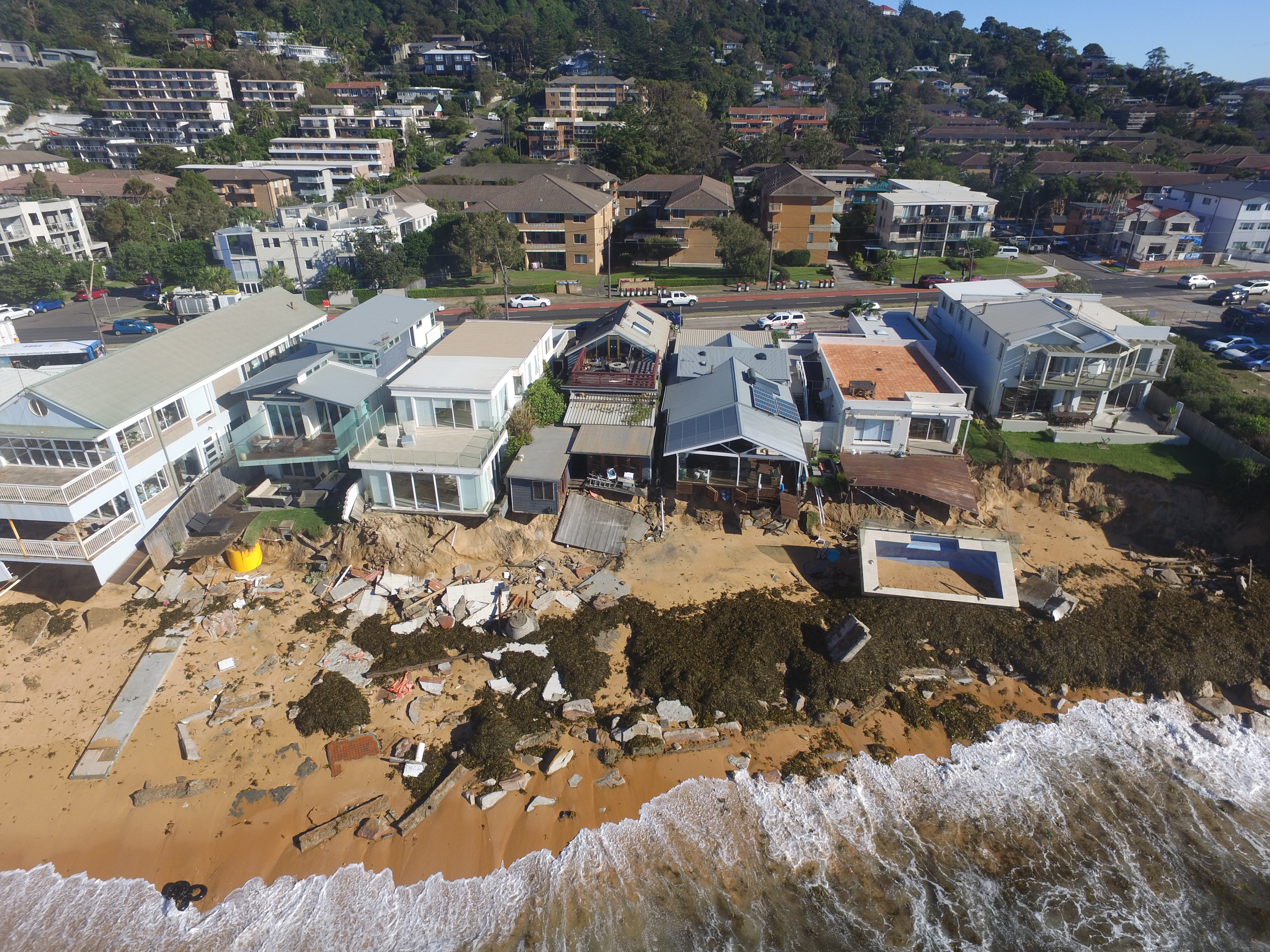 Extreme storms can cause extensive damage to beachfront properties. This was the aftermath from a storm in 2016 that saw a swimming pool ripped away from a property overlooking Collaroy beach, on Sydney's northern beaches. Image: UNSW Water Research Laboratory