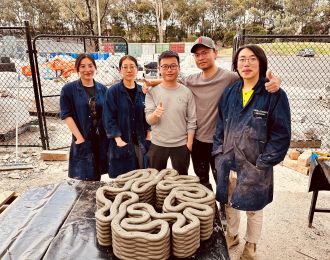 Students with 3D printed concrete structure