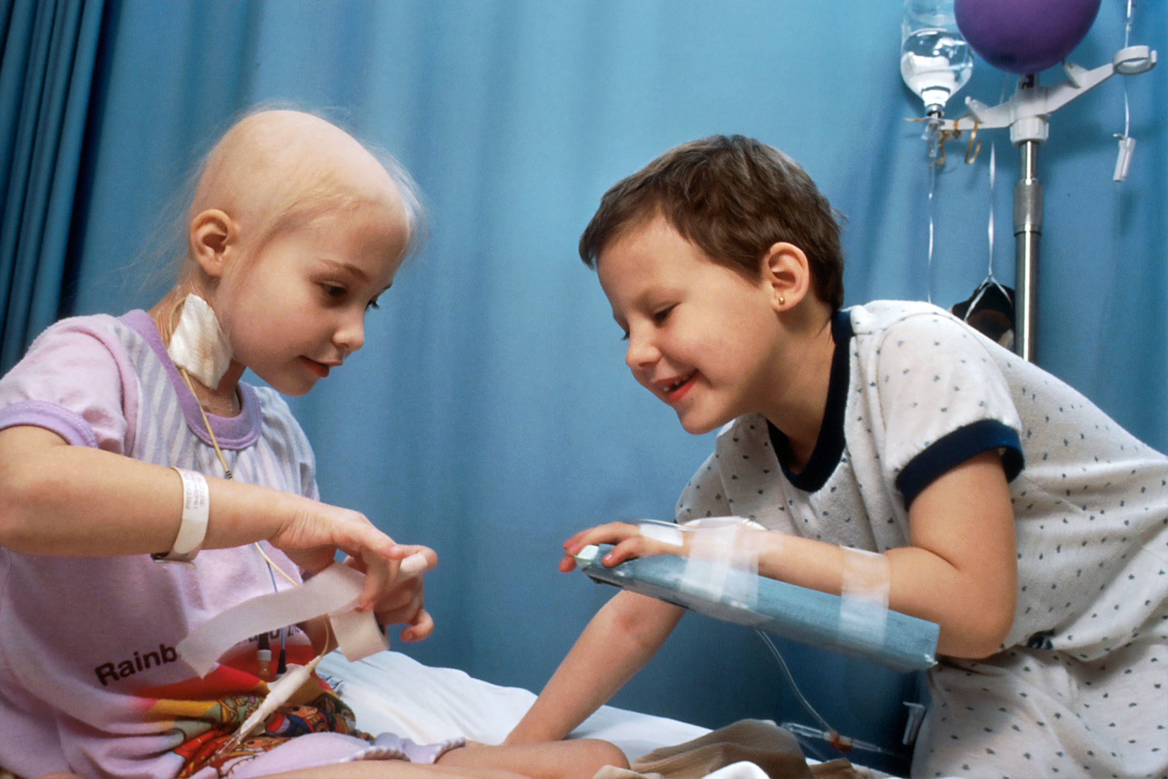 Two young girls with acute lymphocytic leukaemia (ALL) receiving chemotherapy. Credit: National Cancer Institute