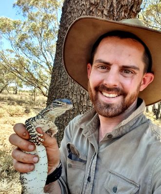 Dr Tim Doherty with sand goanna