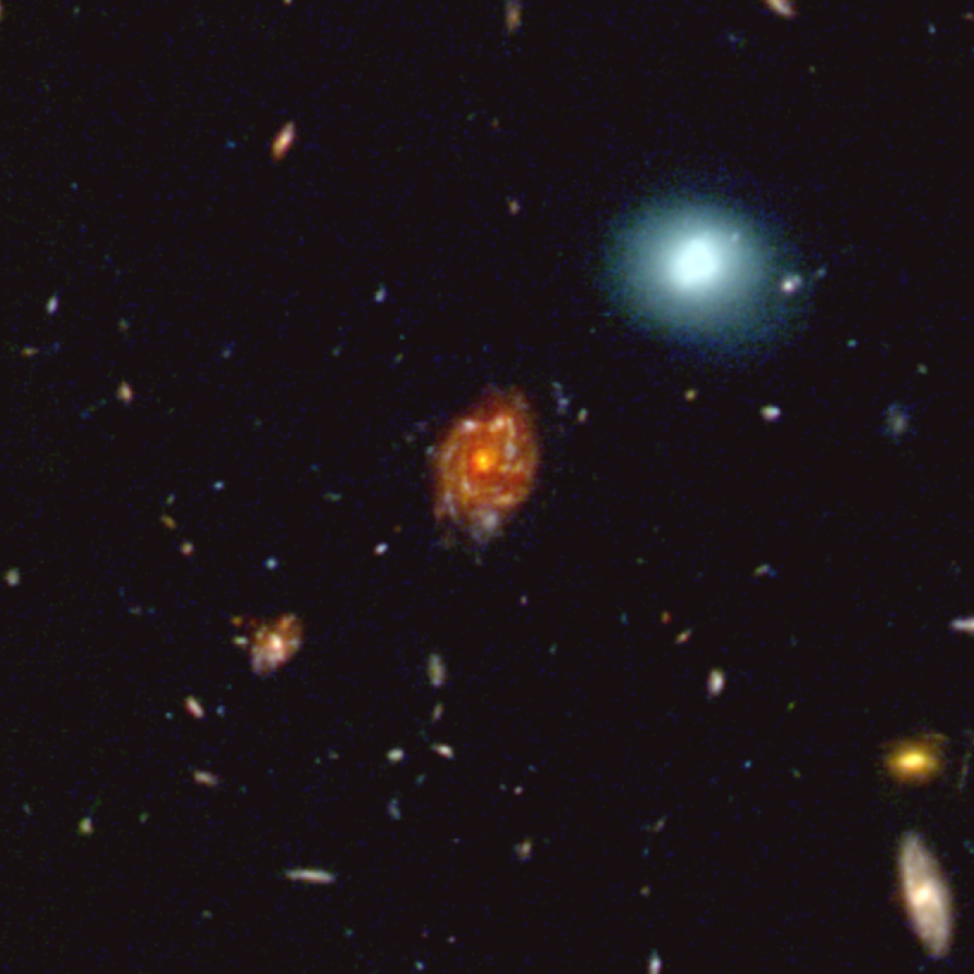 This 25-arcsecond-wide, enhanced RGB image showcases the “Big Wheel” galaxy at redshift 3.25, a cosmic giant whose light has travelled over 12 billion years to reach us. In striking contrast, the bright blue galaxy at the upper right is a nearby object (z≈0.1), only about 1.5 billion light years away, making the Big Wheel roughly 50 times further away. Although both appear similar in angular size on the sky, the enormous distance of the Big Wheel reveals its truly colossal physical scale, underscoring the remarkable growth of galaxies in the early universe.
