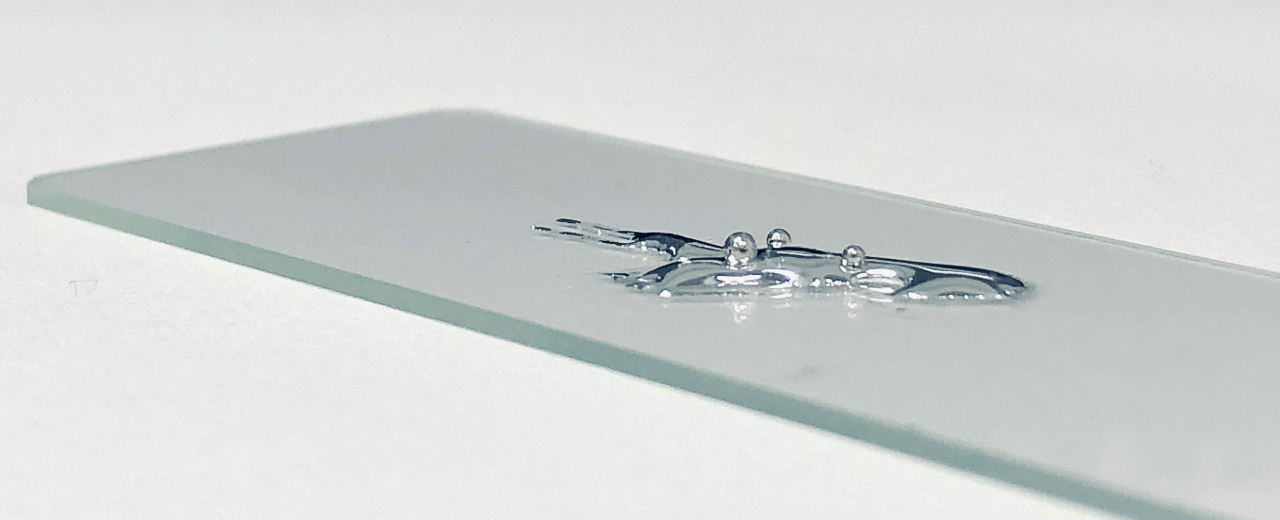 Dr Md. Arifur Rahim, UNSW Sydney / Liquid gallium and three solid beads of platinum, demonstrating the dissolution process of platinum in gallium described in the research paper