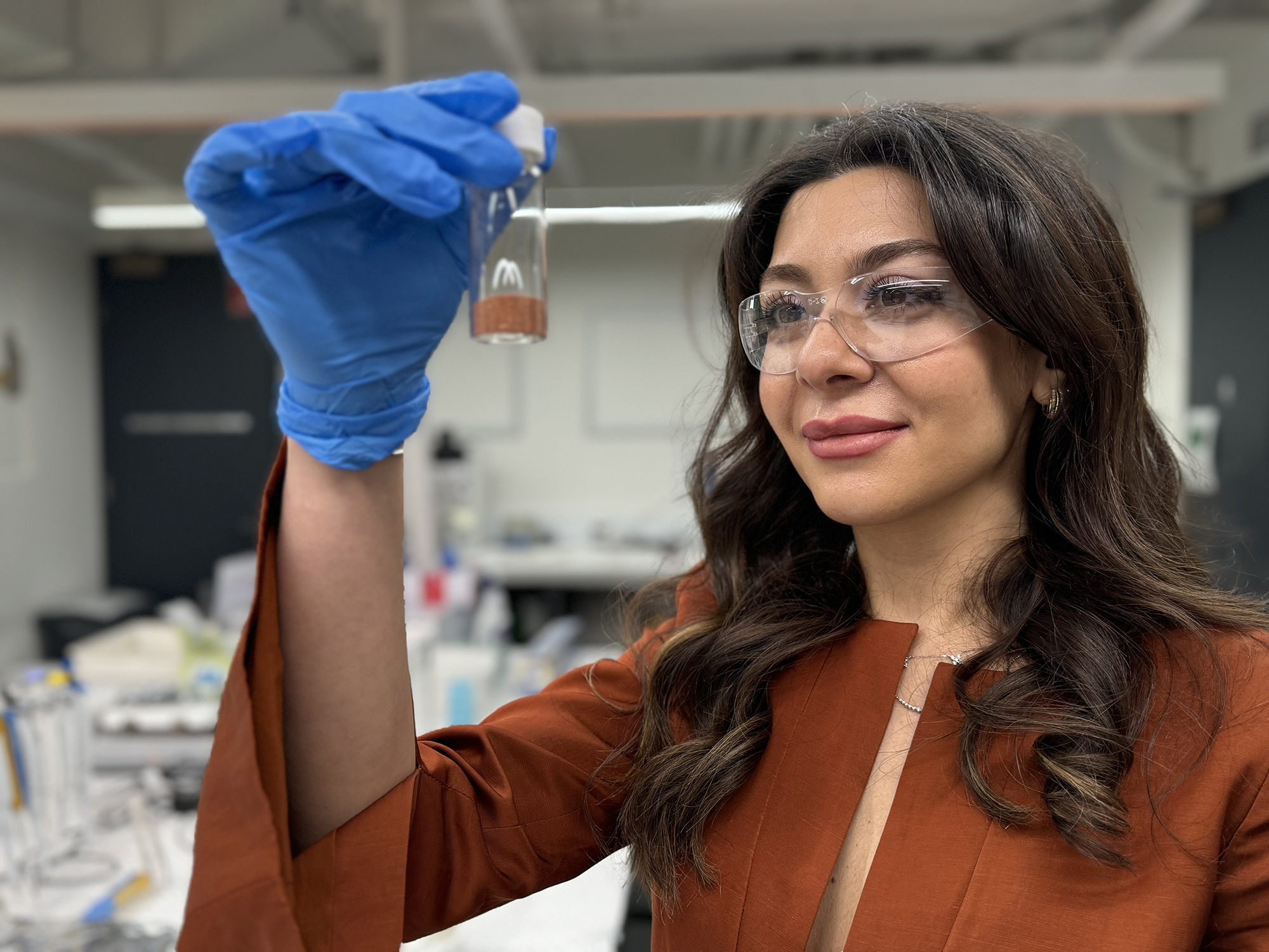 Dr Karma Zuraiqi holds a vial of copper, a key component of the team’s new catalyst. Credit: Michael Quin, RMIT