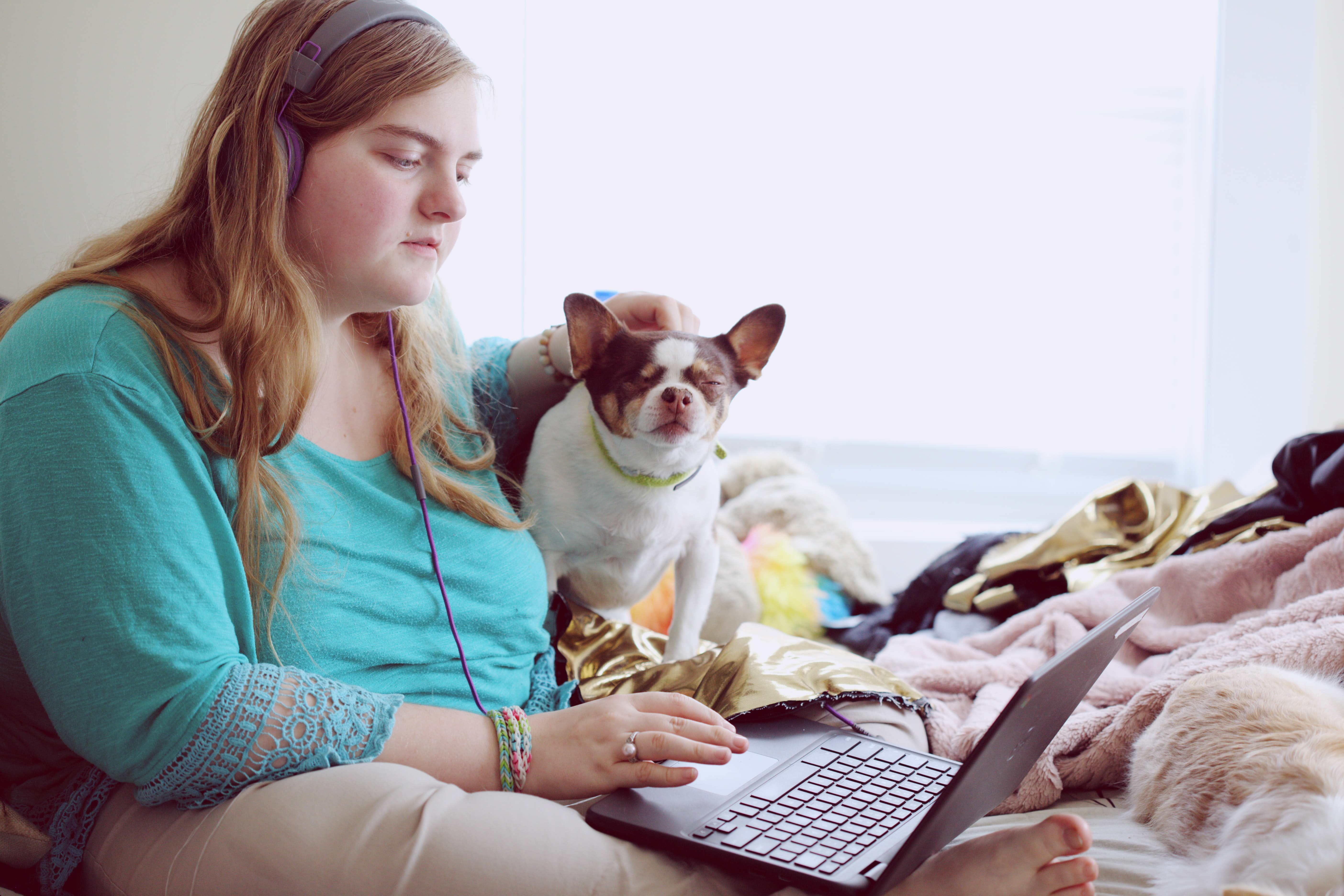 A 19-year-old woman with Autism and other learning disabilities using her laptop at home for school. Photo by Sharon McCutcheon on Unsplash