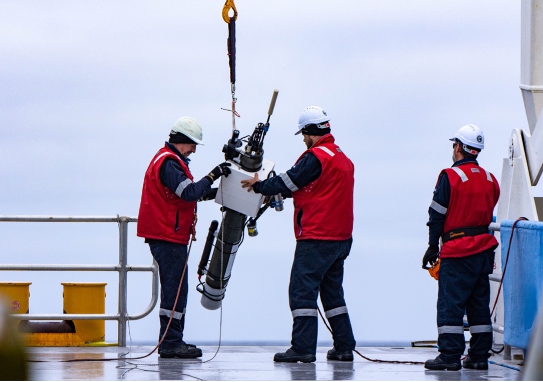 Crew on a ship prepare to drop an Argo float into the sea. Photo: Jakob Weis/UTAS