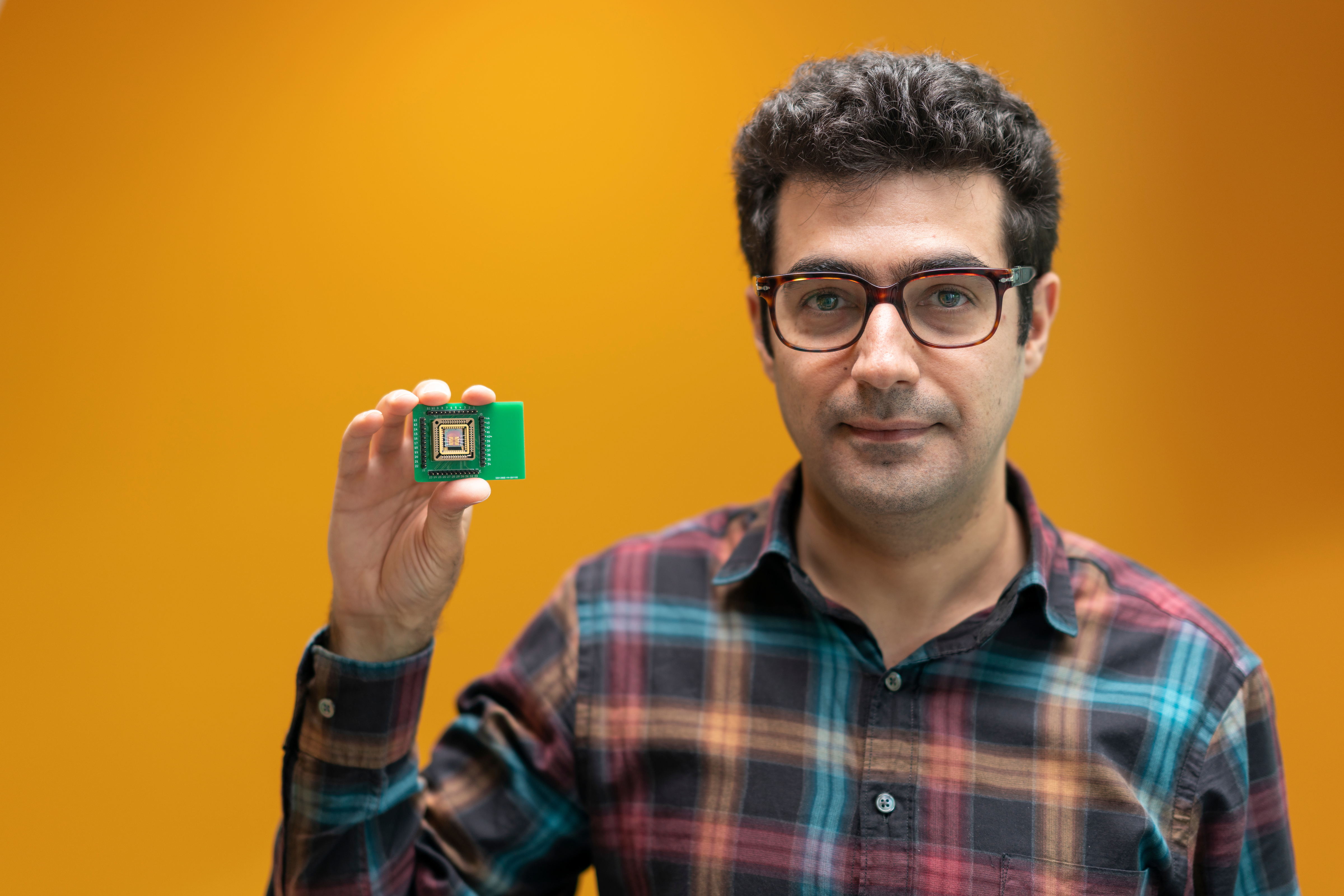 Mr Khosro Zangeneh Kamali is a PhD student in the Experimental photonics group at the ANU Research School of Physics shows the new tech.  Photo: Jamie Kidston/ANU