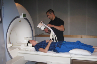 Professor Jim Elliott with a patient in an MRI machine