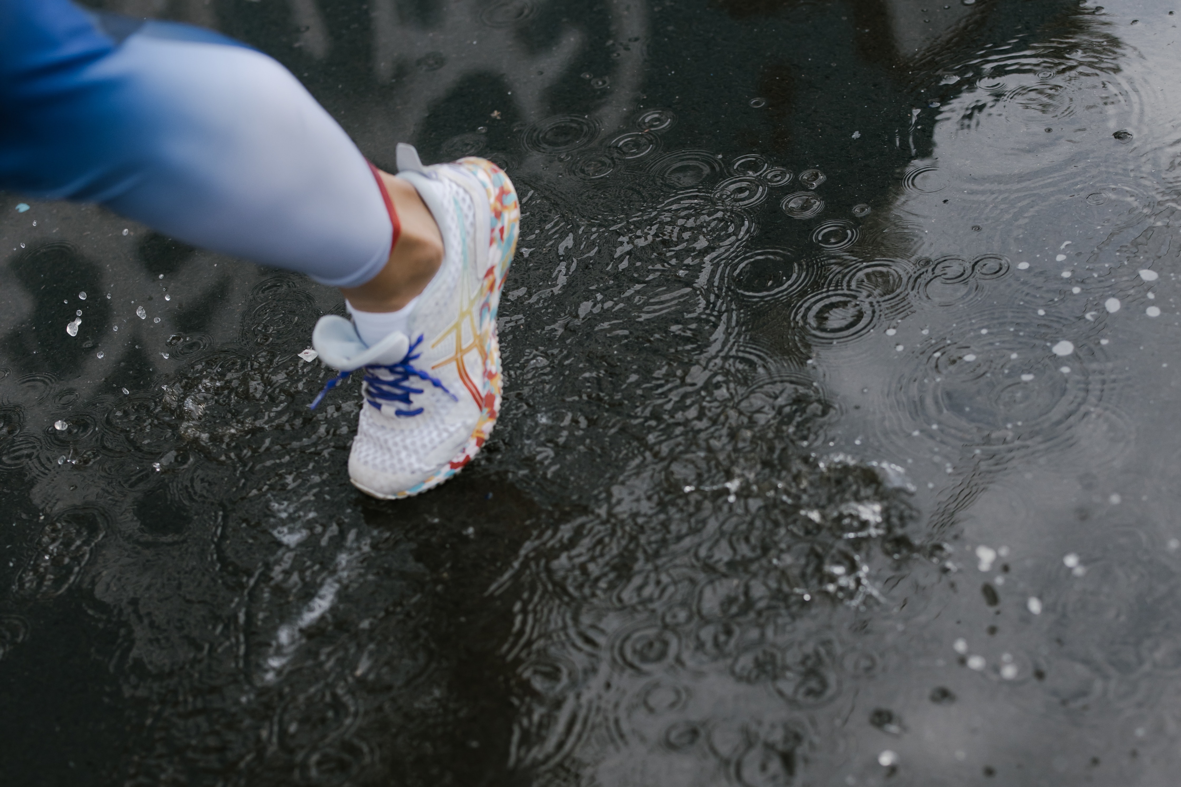 Photo by cottonbro via Pexels (https://www.pexels.com/photo/a-person-wearing-a-white-shoes-while-stepping-on-wet-road-5310918/)