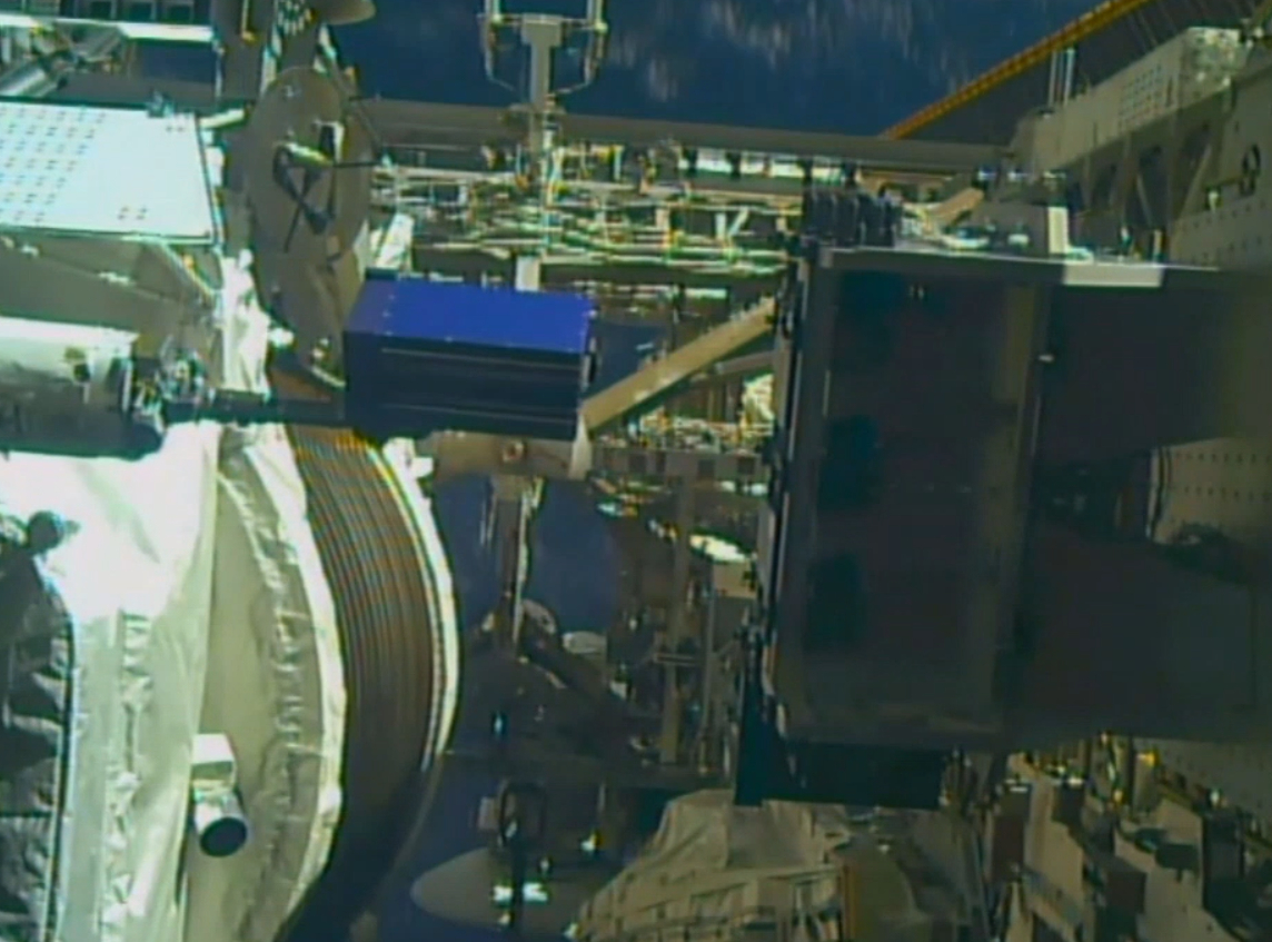 Alpha Space's Materials International Space Station Experiment (MISSE) carrier being loaded into the testing facility located on the outside of the International Space Station (ISS) as it orbits the Earth. Image courtesy of Alpha Space.