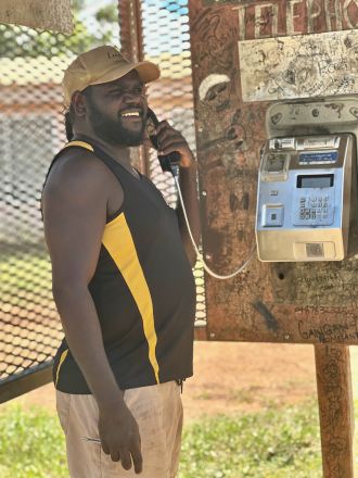 Gangan co-researcher Djamika Ganambarr uses the public phone 