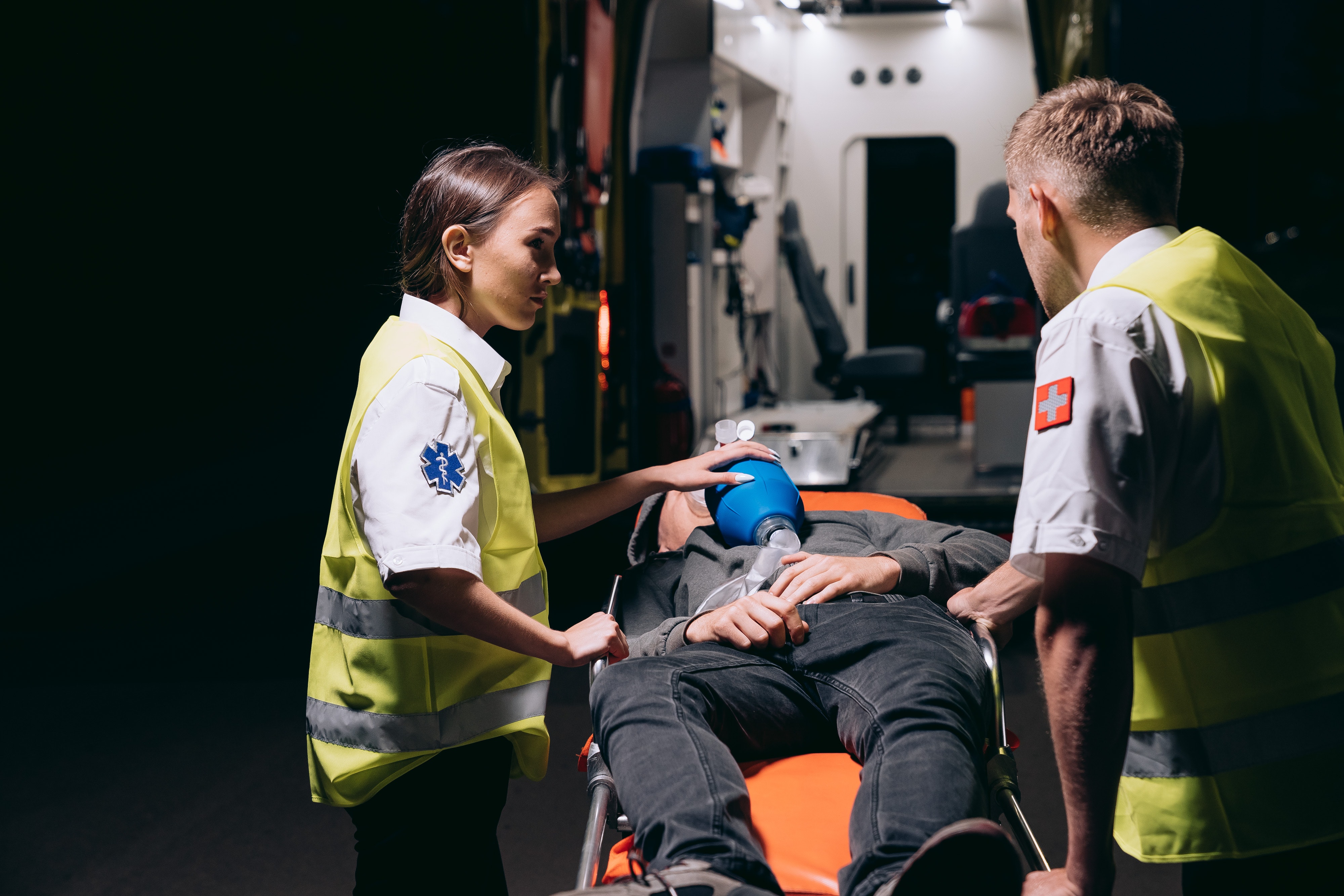 CC-0. Credit: Mikhail Nilov on Pexels. https://www.pexels.com/photo/paramedics-giving-first-aid-to-a-person-lying-on-a-stretcher-8942726/